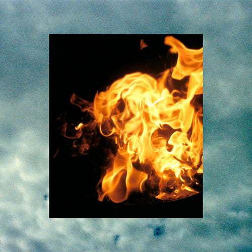 A square photo of bright orange and yellow flames against a black background, centred on a textured blue-gray cloud backdrop.