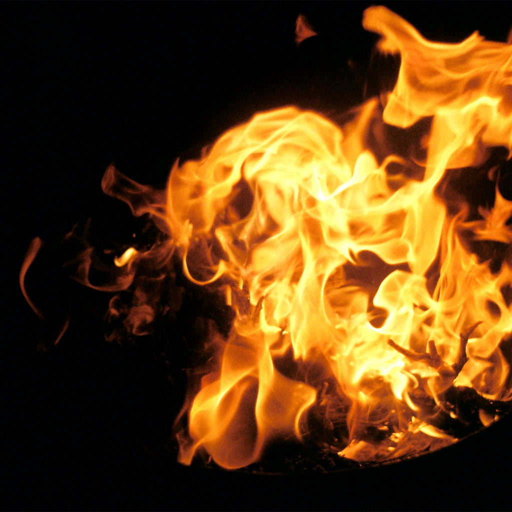 Vibrant orange and yellow flames dancing upward against a solid black background.